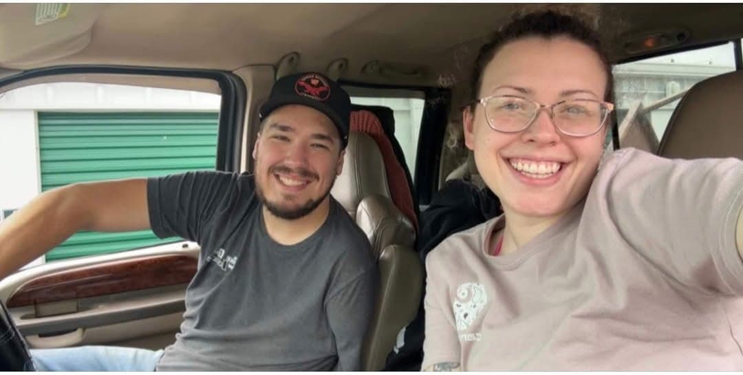 The owners of Missouri Junkers smiling in the truck cab
